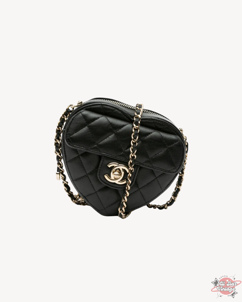 Full view of the Chanel Mini CC In Love Heart Crossbody with its leather-woven chain strap and iconic heart-shaped silhouette