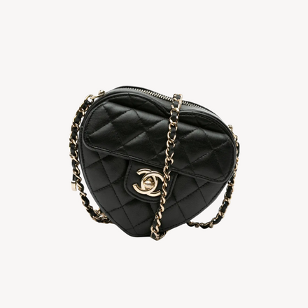 Full view of the Chanel Mini CC In Love Heart Crossbody with its leather-woven chain strap and iconic heart-shaped silhouette