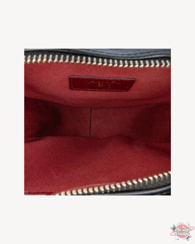 Detailed view of the Chanel Mini CC In Love Heart Crossbody's interior compartment, showcasing the spacious red fabric lining