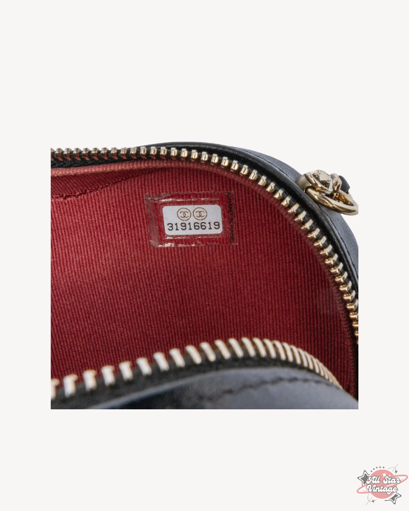 Interior view of the Chanel Mini CC In Love Heart Crossbody showing the serial tag and vibrant red lining