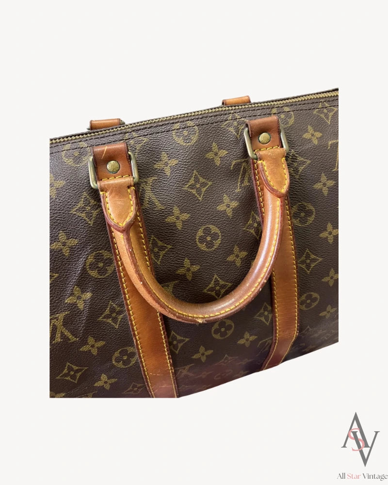 Close-up of the stitching on the leather handle of the Louis Vuitton monogram duffle bag