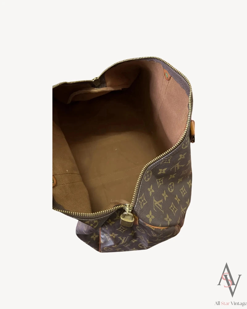 Interior view of the Louis Vuitton monogram duffle bag showcasing its clean, spacious, and well-maintained brown fabric lining