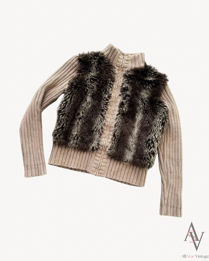 Angled view of a taupe ribbed knit cardigan with a faux fur panel, showcasing its relaxed fit, soft texture, and high-collared zip-up design