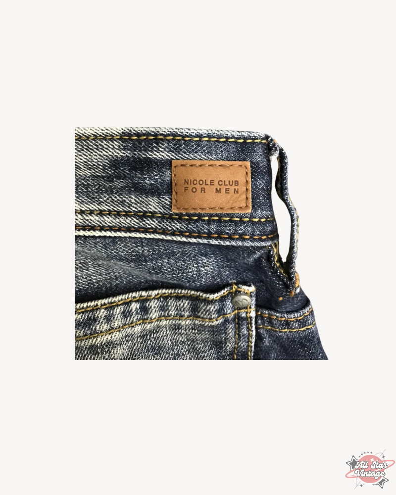 Close-up of the brand label on Vintage Flare NCFM Japan Distressed Faded Jeans featuring 'NICOLE CLUB FOR MEN' embossed on leather, adding a touch of luxury to this streetwear piece.