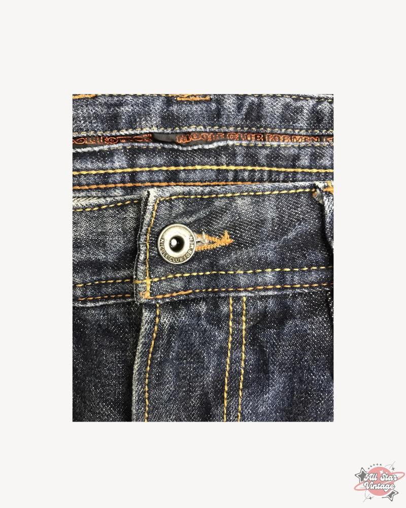 Close-up of Vintage Flare NCFM Japan Distressed Faded Jeans showcasing high-quality craftsmanship, featuring branded rivets and detailed stitching for a bold streetwear look.