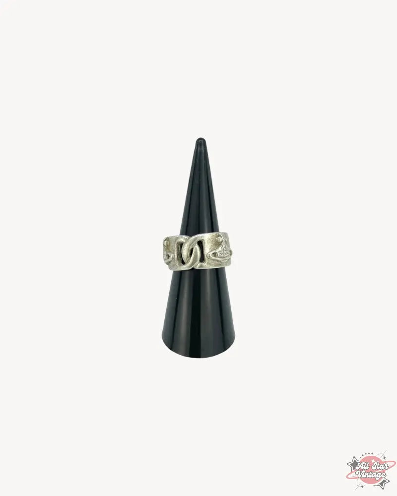 Frontal view of the Vivienne Westwood Chain-Link Orb Ring on a black jewellery cone