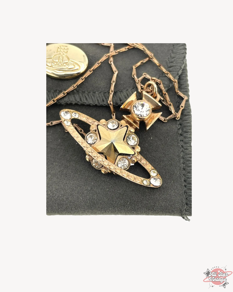 Vivienne Westwood Crystal Star Orb Necklace in gold displayed with box and chain, highlighting elegant design and craftsmanship. Perfect luxury accessory