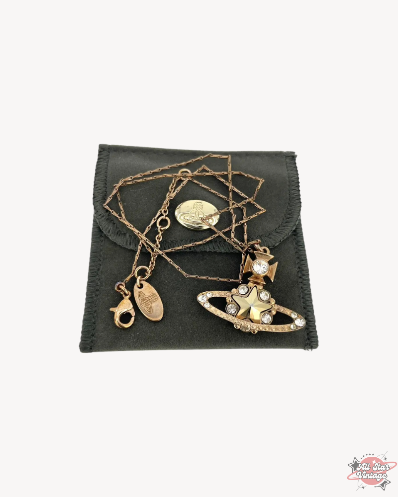 Vivienne Westwood Crystal Star Orb Necklace in gold, displayed with chain and pouch. A luxury statement piece perfect for elegant styles.