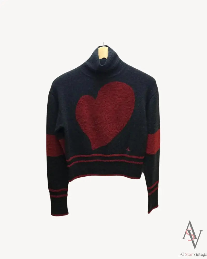 Front view of a Vivienne Westwood Red Label knit sweater, featuring a bold red heart intarsia design on a navy background with red striped details